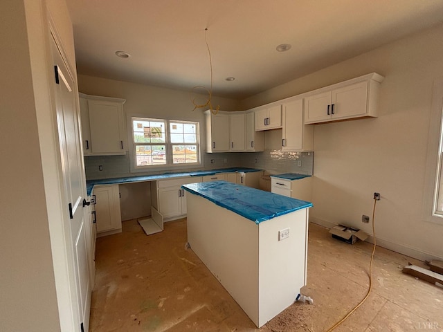5 Live Oak Dr, Forest, VA 24551 - kitchen featuring a center island, tasteful backsplash, and white cabinetry