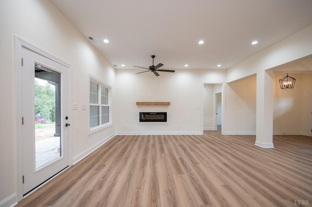 5 Live Oak Dr, Forest, VA 24551 - unfurnished living room with light wood-type flooring, recessed lighting, ceiling fan with notable chandelier, and a glass covered fireplace