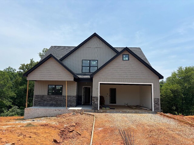 5 Live Oak Dr, Forest, VA 24551 - craftsman-style house featuring stone siding, an attached garage, and dirt driveway