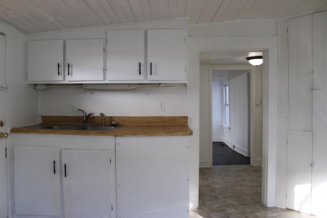 2127 Hanover St, Lynchburg, VA 24501 - kitchen with a sink, wooden ceiling, tile patterned floors, and white cabinetry
