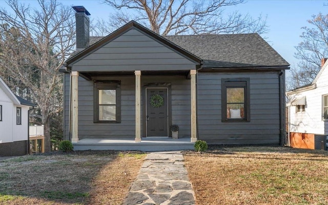 319 Kemper Rd, Danville, VA 24541 - bungalow with covered porch, a chimney, and roof with shingles