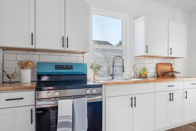 319 Kemper Rd, Danville, VA 24541 - kitchen with electric range, tasteful backsplash, a sink, and light countertops