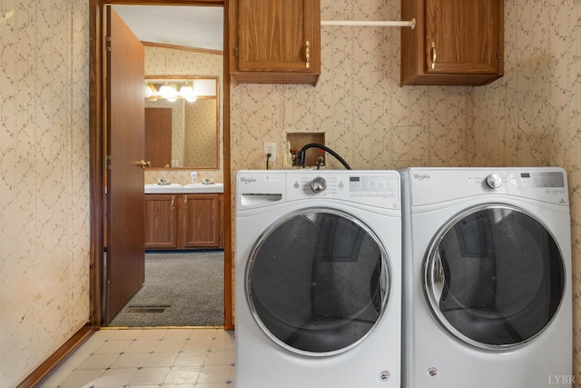 550 Mitchell Rd, Axton, VA 24054 - laundry area featuring washer and dryer, light flooring, cabinet space, wallpapered walls, and baseboards