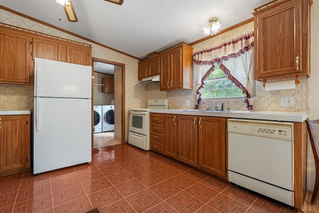 550 Mitchell Rd, Axton, VA 24054 - kitchen featuring white appliances, wallpapered walls, lofted ceiling, separate washer and dryer, and a sink