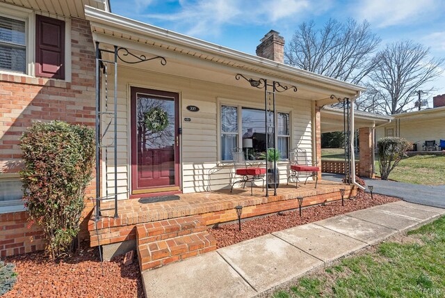 337 Virginia Ave, Appomattox, VA 24522 - entrance to property with a porch, a chimney, and brick siding