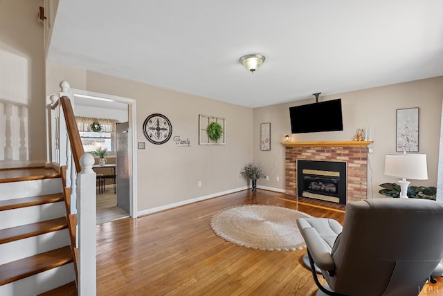 337 Virginia Ave, Appomattox, VA 24522 - living area featuring wood finished floors, stairs, and a brick fireplace