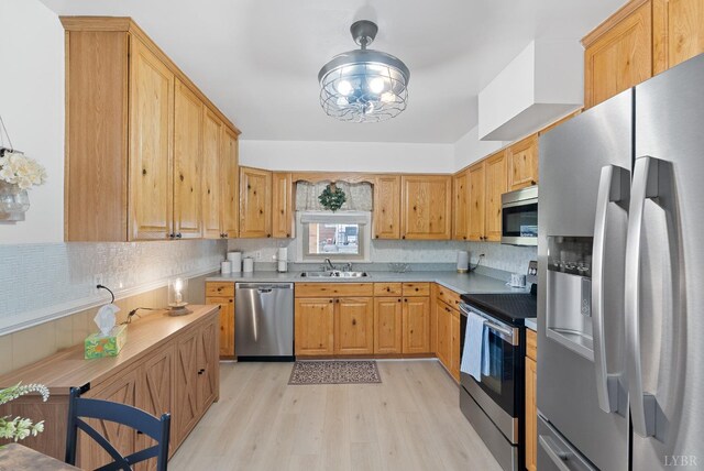 337 Virginia Ave, Appomattox, VA 24522 - kitchen featuring appliances with stainless steel finishes, light wood-type flooring, a sink, and light countertops