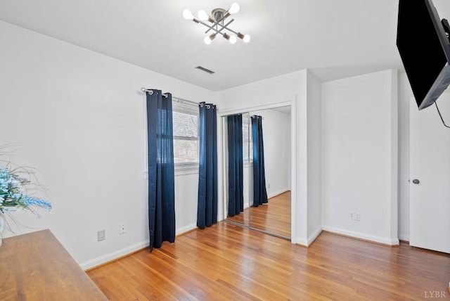 337 Virginia Ave, Appomattox, VA 24522 - empty room featuring a chandelier, light wood-type flooring, and baseboards