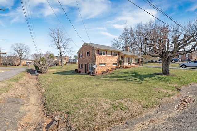 337 Virginia Ave, Appomattox, VA 24522 - view of side of home featuring brick siding, a chimney, and a lawn