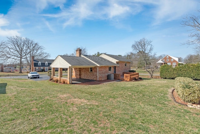 337 Virginia Ave, Appomattox, VA 24522 - back of property featuring brick siding, a lawn, and a chimney