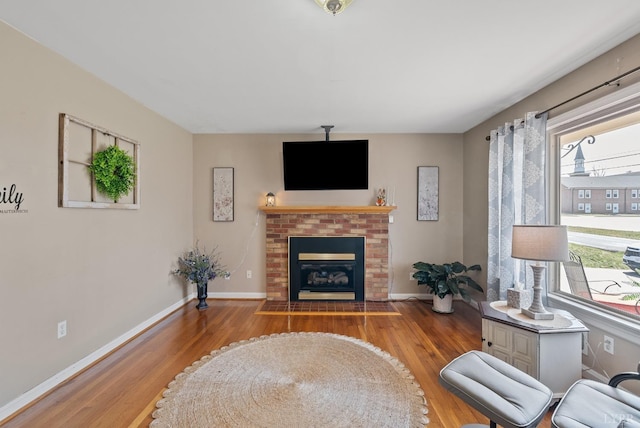 337 Virginia Ave, Appomattox, VA 24522 - living area with wood finished floors, baseboards, and a fireplace