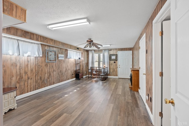 337 Virginia Ave, Appomattox, VA 24522 - interior space with ceiling fan, wood finished floors, wood walls, baseboards, and a textured ceiling