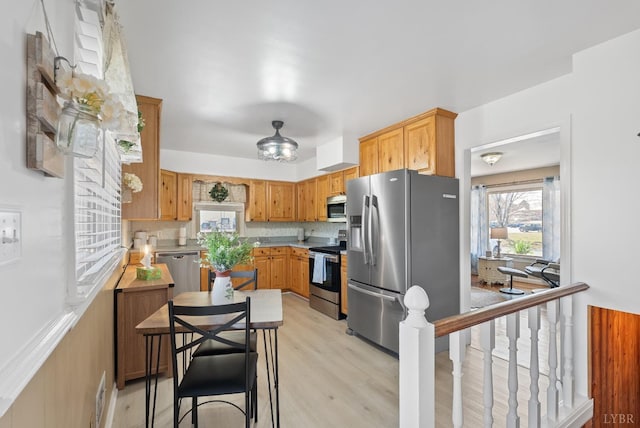 337 Virginia Ave, Appomattox, VA 24522 - kitchen with appliances with stainless steel finishes, healthy amount of natural light, light wood finished floors, and light countertops