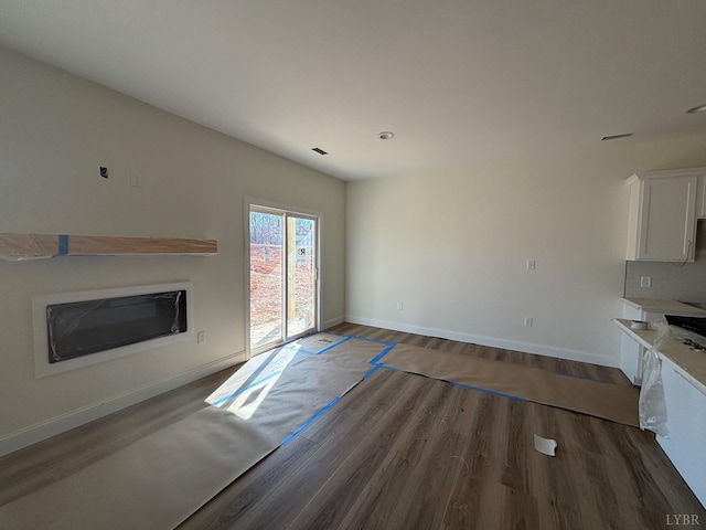 1018 Misty Mountain Rd, Lynchburg, VA 24502 - unfurnished living room with wood finished floors, baseboards, and a glass covered fireplace