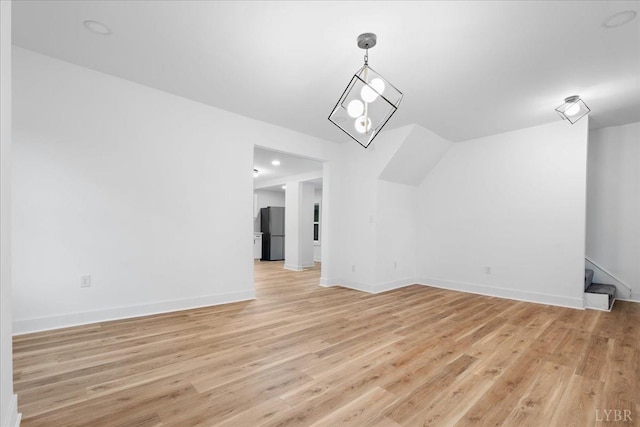 623 Monroe St, Lynchburg, VA 24504 - additional living space with light wood-type flooring, baseboards, stairway, and vaulted ceiling