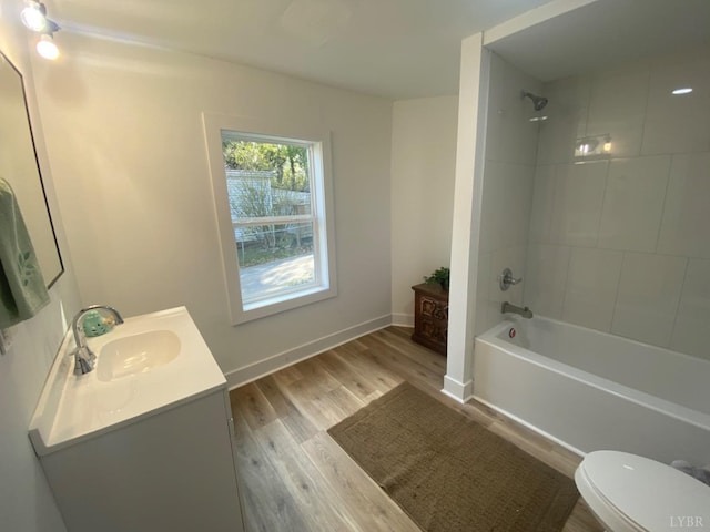 623 Monroe St, Lynchburg, VA 24504 - full bathroom with wood finished floors, toilet, shower / bathtub combination, vanity, and baseboards