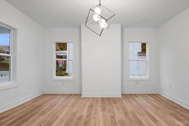 623 Monroe St, Lynchburg, VA 24504 - unfurnished room featuring light wood finished floors, baseboards, and a chandelier