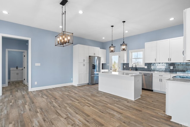 2135 Bellevue Rd, Forest, VA 24551 - kitchen featuring appliances with stainless steel finishes, tasteful backsplash, a kitchen island, wood finished floors, and recessed lighting