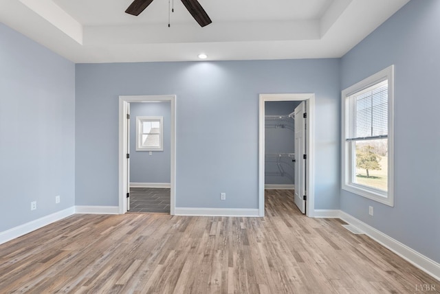 2135 Bellevue Rd, Forest, VA 24551 - unfurnished bedroom with a tray ceiling, light wood-type flooring, a spacious closet, a closet, and recessed lighting