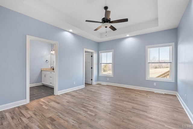 2135 Bellevue Rd, Forest, VA 24551 - unfurnished bedroom featuring wood finished floors, a tray ceiling, recessed lighting, connected bathroom, and a ceiling fan