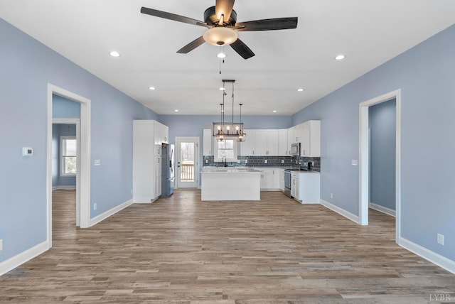 2135 Bellevue Rd, Forest, VA 24551 - kitchen featuring appliances with stainless steel finishes, open floor plan, ceiling fan, tasteful backsplash, and light wood finished floors