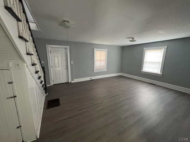 800 Spring St, Lynchburg, VA 24504 - unfurnished living room featuring baseboards, dark wood-style flooring, and stairs