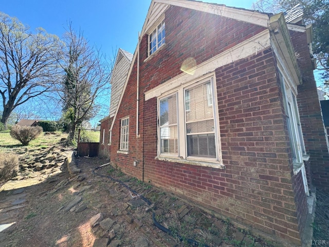 view of side of home featuring brick siding