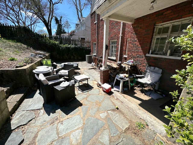 view of patio with cooling unit, an outdoor hangout area, and fence
