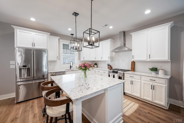 706 Elmwood Ave, Lynchburg, VA 24503 - kitchen featuring a sink, wall chimney exhaust hood, white cabinetry, a center island, and appliances with stainless steel finishes