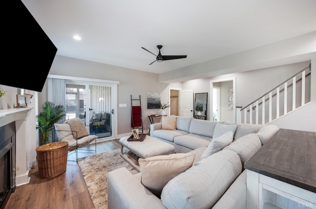 706 Elmwood Ave, Lynchburg, VA 24503 - living area with stairs, wood finished floors, a fireplace, a ceiling fan, and baseboards