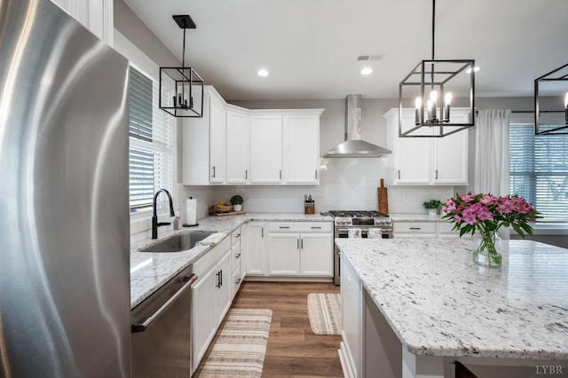 706 Elmwood Ave, Lynchburg, VA 24503 - kitchen with a sink, wall chimney exhaust hood, a notable chandelier, visible vents, and appliances with stainless steel finishes