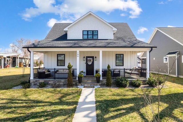 706 Elmwood Ave, Lynchburg, VA 24503 - view of front facade featuring board and batten siding, a porch, roof with shingles, and a front lawn