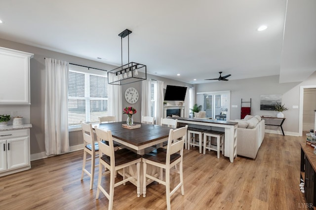 706 Elmwood Ave, Lynchburg, VA 24503 - dining area featuring light wood finished floors, a fireplace, and a ceiling fan