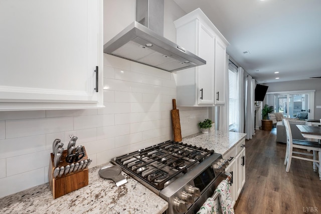 706 Elmwood Ave, Lynchburg, VA 24503 - kitchen featuring white cabinetry, wall chimney range hood, gas stove, and tasteful backsplash