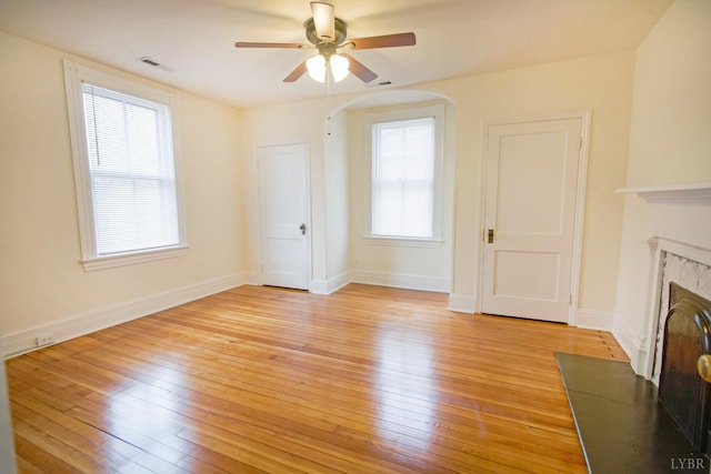 226 Denver Ave, Lynchburg, VA 24503 - unfurnished living room with baseboards, light wood finished floors, ceiling fan, visible vents, and a fireplace