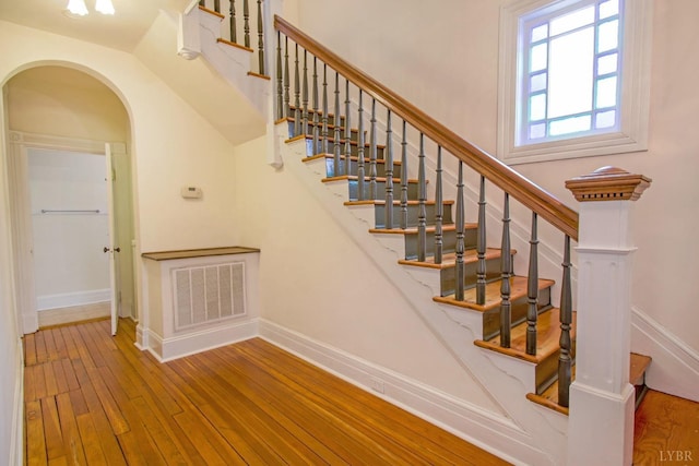 226 Denver Ave, Lynchburg, VA 24503 - stairway with baseboards, hardwood / wood-style floors, visible vents, and arched walkways