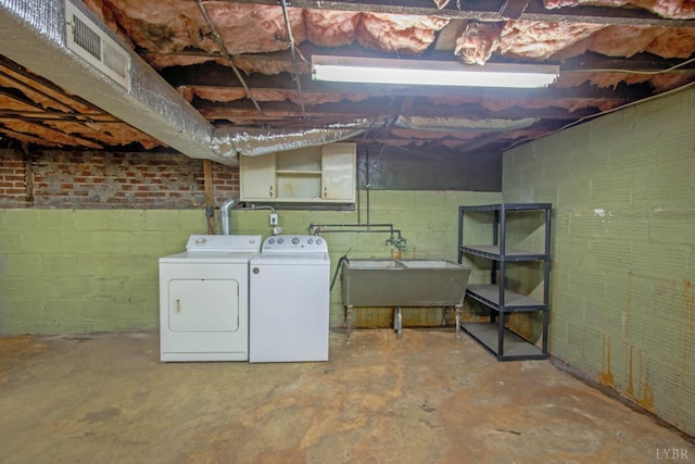226 Denver Ave, Lynchburg, VA 24503 - unfinished basement featuring brick wall, washing machine and dryer, visible vents, and a sink