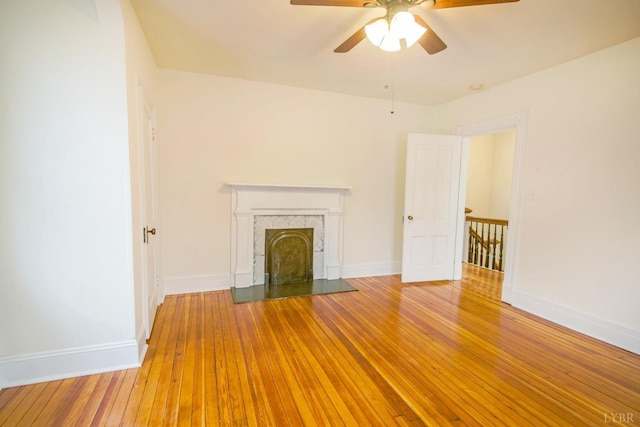 226 Denver Ave, Lynchburg, VA 24503 - unfurnished living room with a premium fireplace, baseboards, a ceiling fan, and wood-type flooring