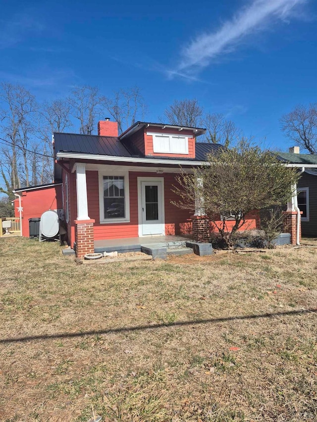 2608 Old Forest Rd, Lynchburg, VA 24501 - bungalow-style home featuring a porch, a front lawn, a chimney, and metal roof