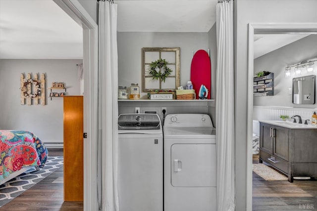 6892 Tolers Ferry Rd, Huddleston, VA 24104 - laundry area featuring a wainscoted wall, a sink, separate washer and dryer, and wood finished floors
