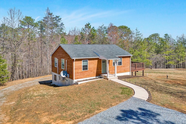 6892 Tolers Ferry Rd, Huddleston, VA 24104 - rustic home with roof with shingles, driveway, a view of trees, and a front lawn