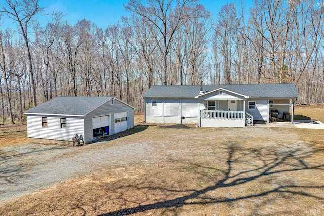 504 Spinnaker Way, Moneta, VA 24121 - view of front of house featuring covered porch, a garage, an outbuilding, and roof with shingles