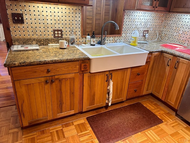 506 Peters Hollow Rd, Monroe, VA 24574 - kitchen featuring brown cabinetry, stone countertops, tasteful backsplash, and a sink