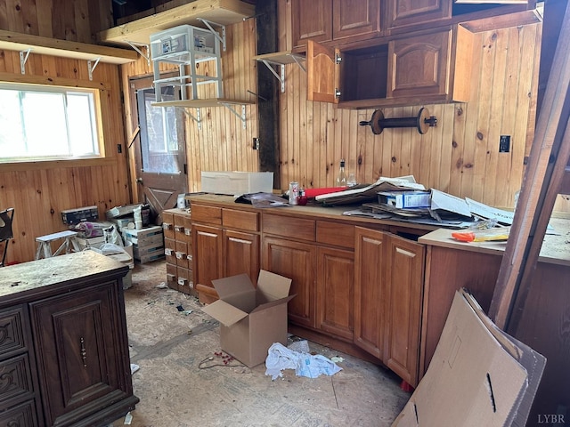 506 Peters Hollow Rd, Monroe, VA 24574 - kitchen with light countertops, wooden walls, and brown cabinetry