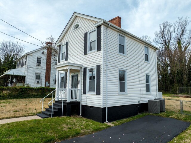 1640 Shaffer St, Lynchburg, VA 24501 - view of front facade with crawl space, cooling unit, a chimney, and fence