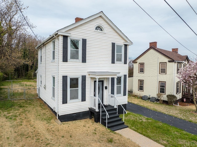 1640 Shaffer St, Lynchburg, VA 24501 - view of front facade featuring cooling unit, a chimney, a front lawn, and fence