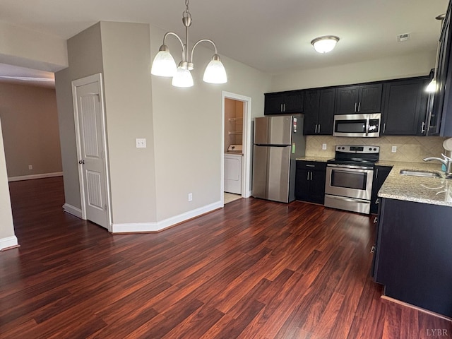 2009 Lakeside Dr Unit 302, Lynchburg, VA 24502 - kitchen featuring appliances with stainless steel finishes, a sink, dark cabinetry, a chandelier, and washer / clothes dryer