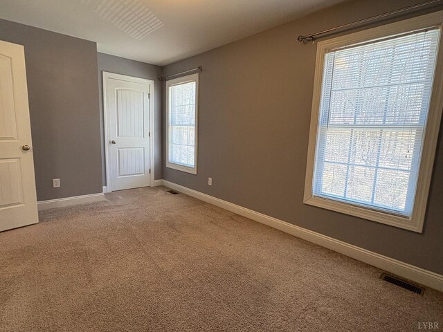 2009 Lakeside Dr Unit 302, Lynchburg, VA 24502 - unfurnished bedroom featuring multiple windows, baseboards, and light colored carpet