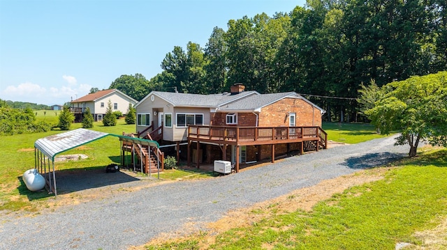 1553 Old Stage Rd, Amherst, VA 24521 - view of front of house with a deck, a front yard, brick siding, a carport, and gravel driveway