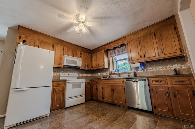 1553 Old Stage Rd, Amherst, VA 24521 - kitchen featuring white appliances, dark countertops, brown cabinets, a ceiling fan, and a textured ceiling